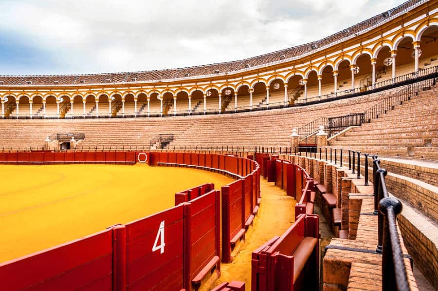 View inside the massive and bright yellow and red bullring of Plaza de Toros in Seville