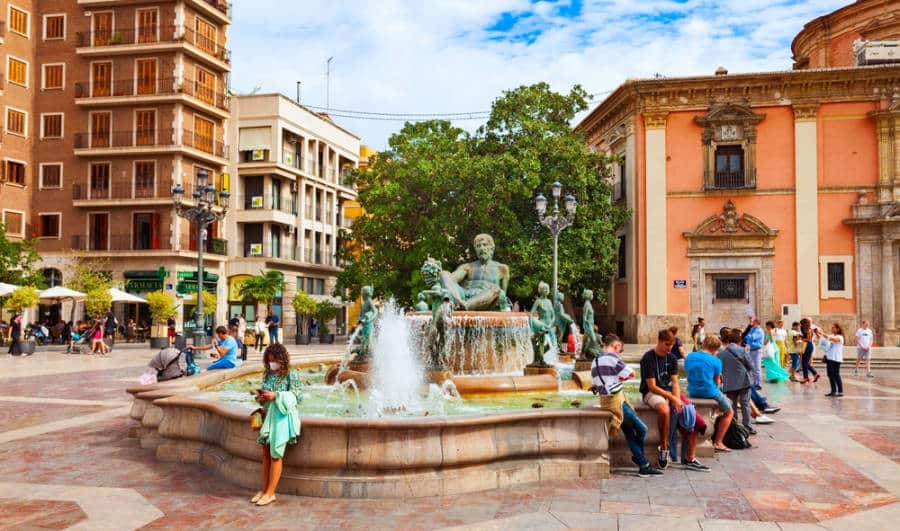 View of people and a water fountain at the Plaza de la Virgen
