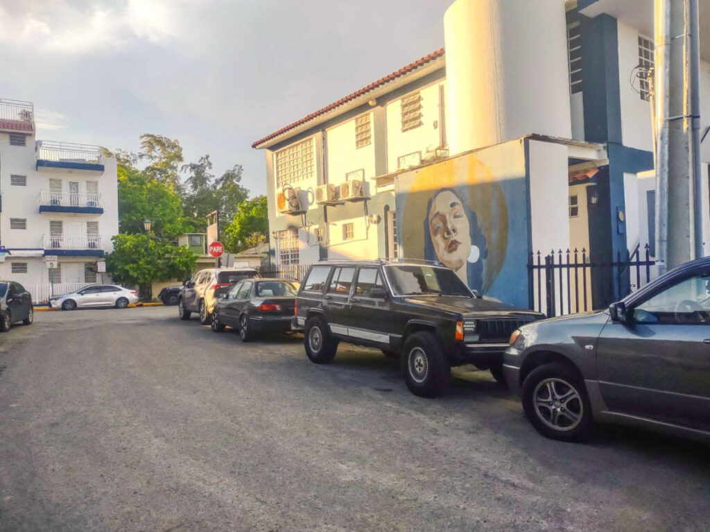 View of the parked vehicles and a mural at Poblado Boquerón in Cabo Rojo