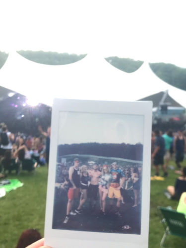 Polaroid photo of group of friends in Camp Bisco