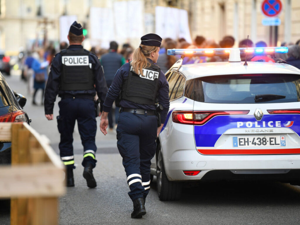 Paris' police officers ensuring security with a police car