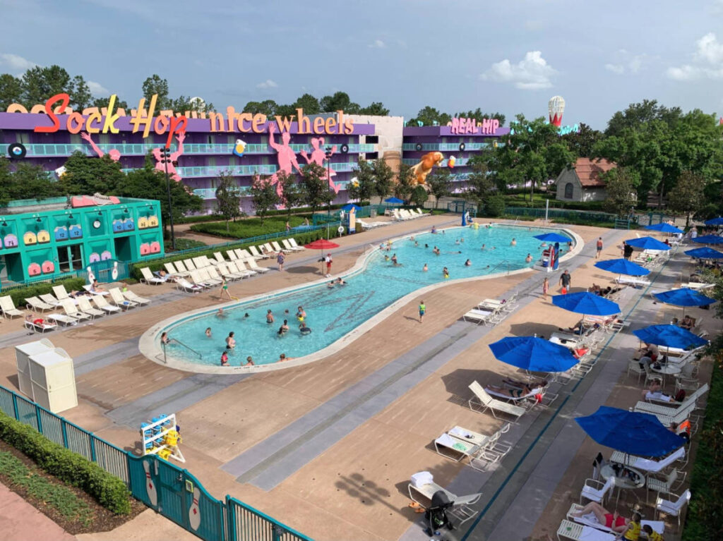 People enjoying their day at the pool area in Pop Century