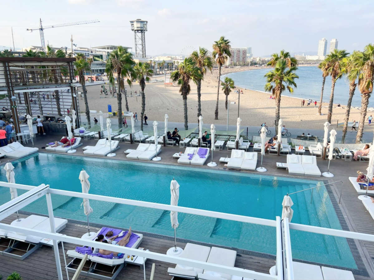 Overlooking view of the pool area of The W Barcelona and the Barceloneta beach