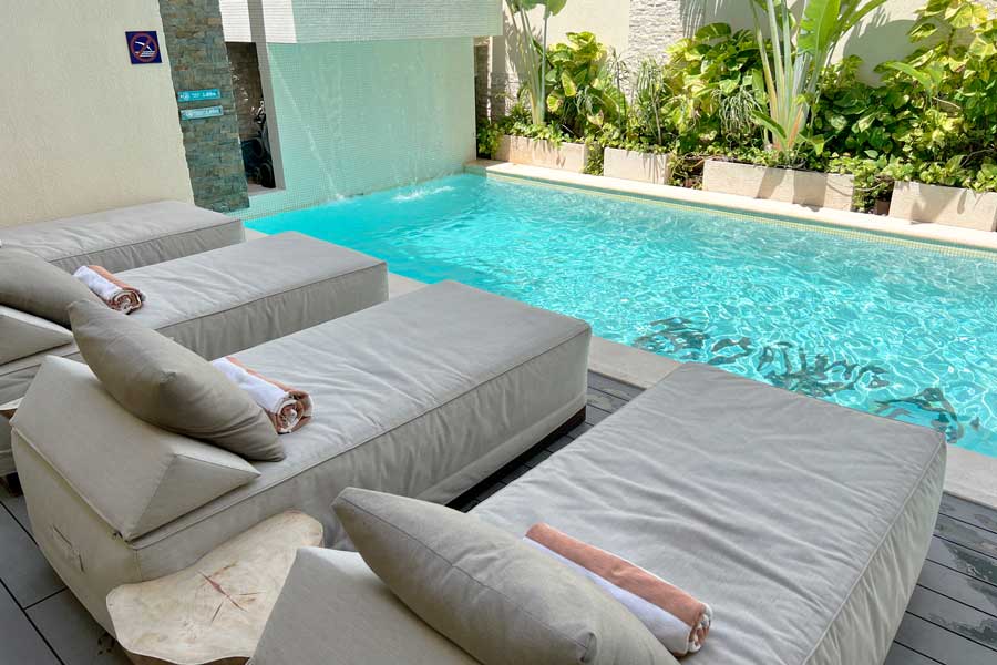 Pool chairs on the pool area of Hotel Biwa Tulum
