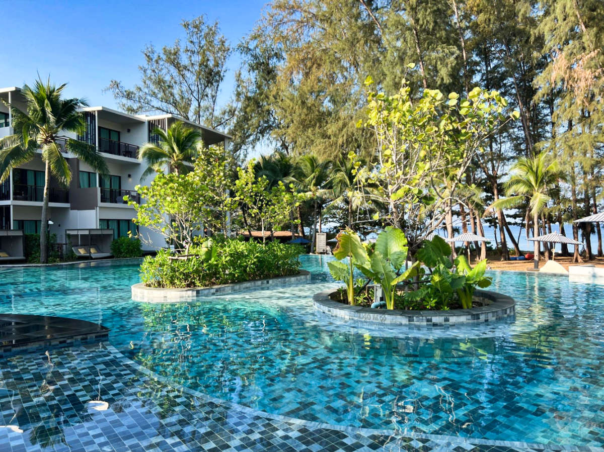 The pool of Le Méridien Phuket Mai Khao surrounded by greenery