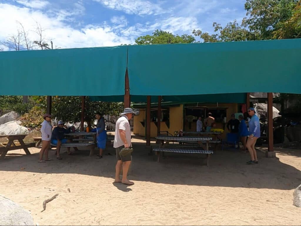 People, tables, and chairs at the Poor Mans Bar