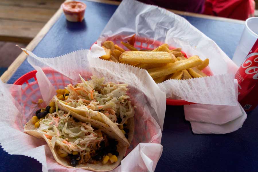 View of a pork tacos and fries on a table in a restaurant in La Esperanza