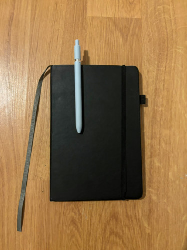 A Portable journal and pen on the table