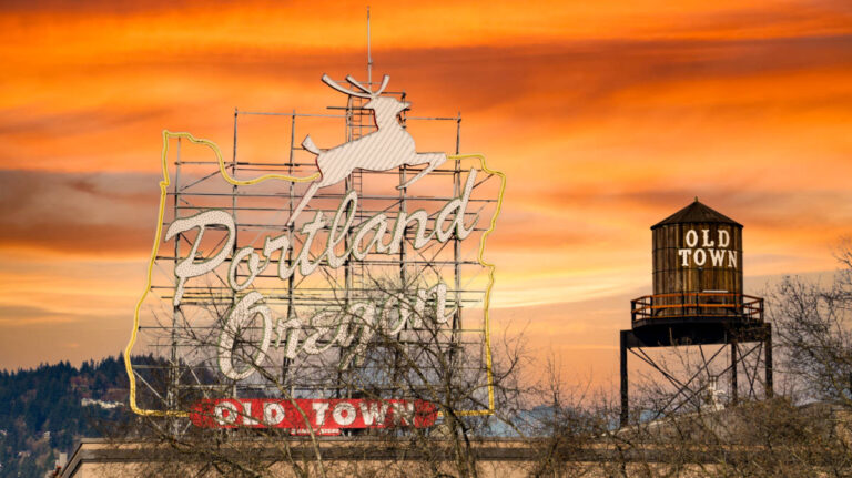 View of the Portland Oregon old town landmark signage with jumping deer at sunset
