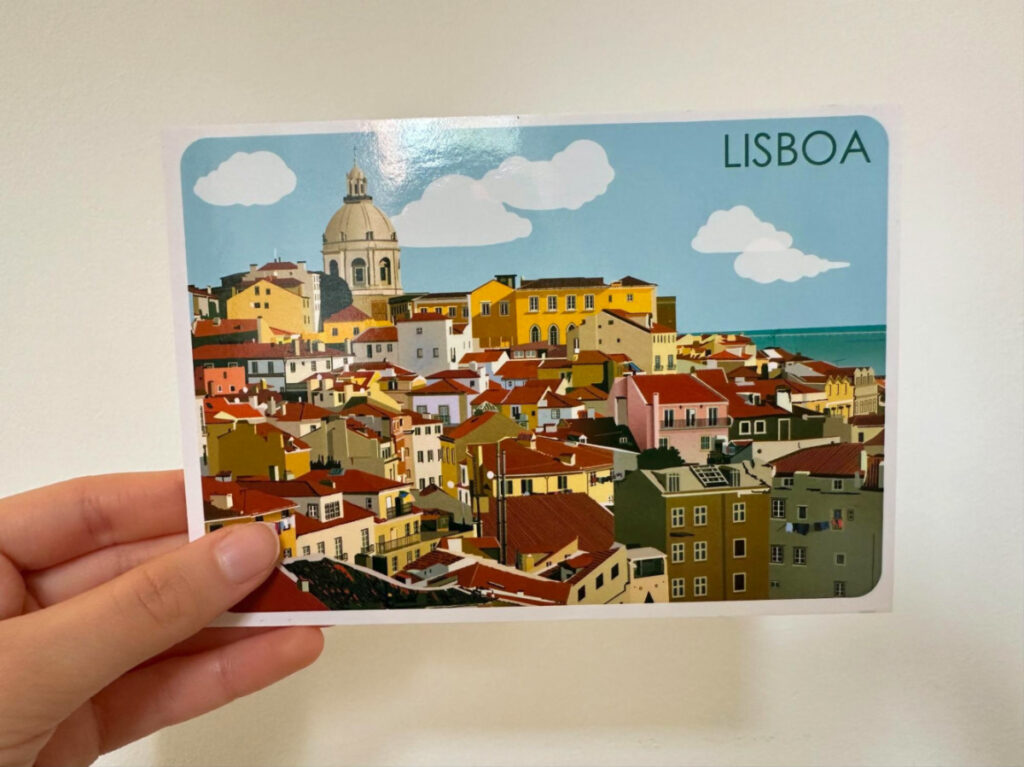 Holding a Postcard from Lisbon