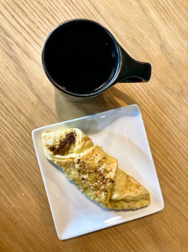 A pourover coffee and a palte of pastry from Sweet Bloom Coffee Roasters