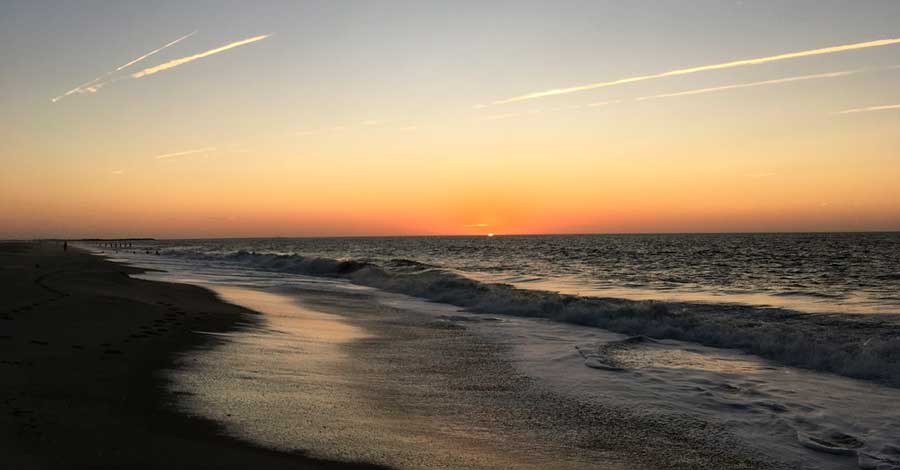 View of the colorful sky during sunrise in Poverty Beach
