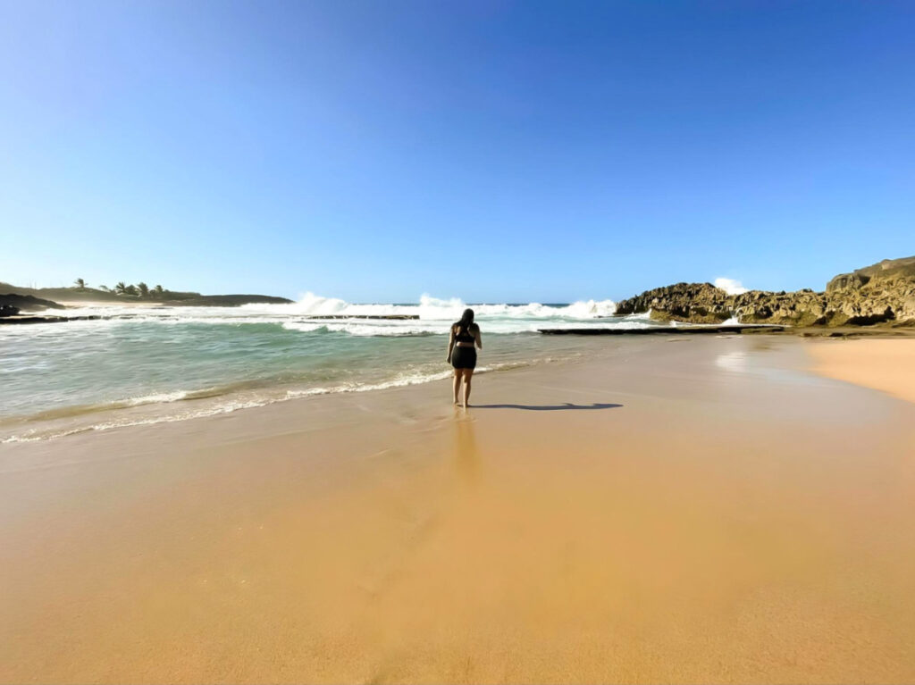 Author Vanessa Ramos strolling on Poza de Las Mujeres beach