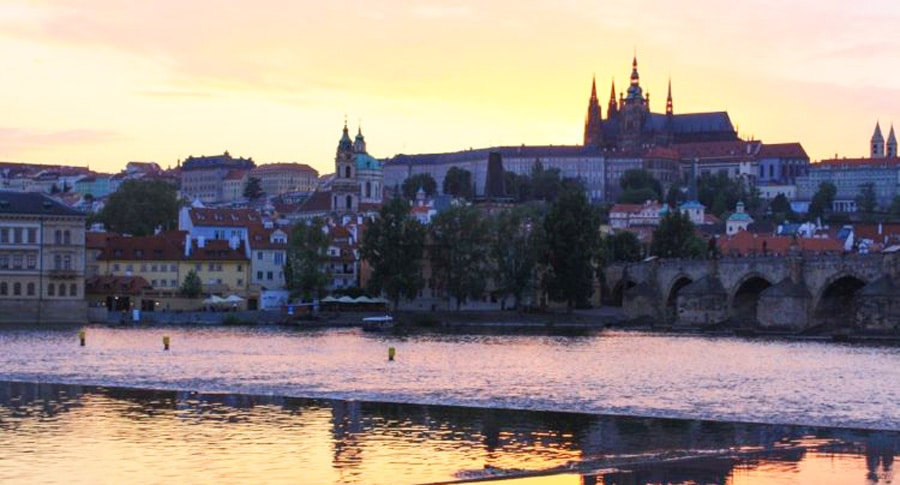 View of the Prague Castle from across the water at sunset