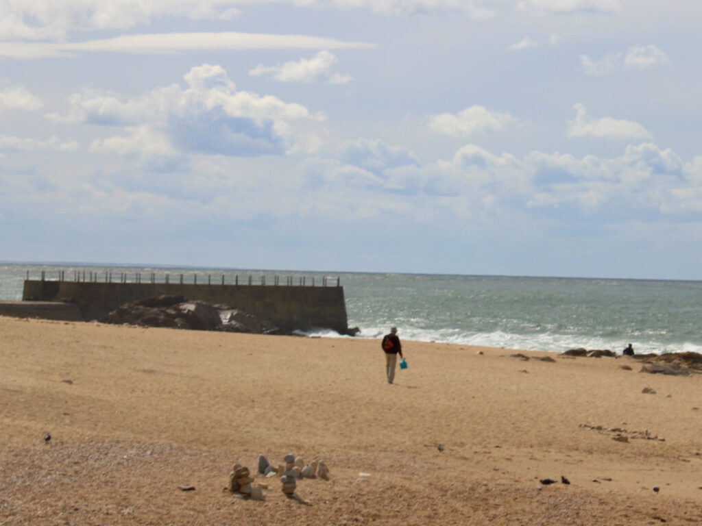 A man walking on the sands at Praia de Gondarém
