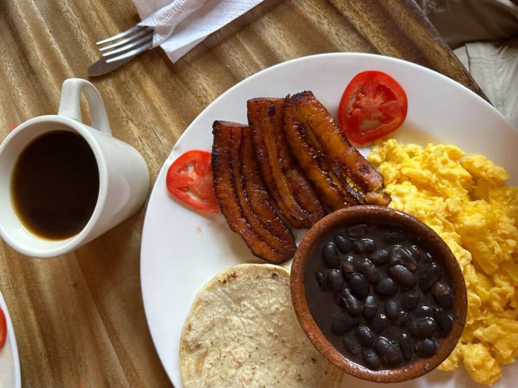 The author's breakfast on a plate and a cup of coffee