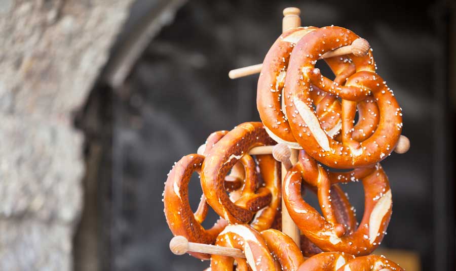Pretzels hanging on a wooden stand