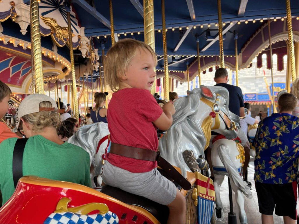 The author's son enjoying the Prince Charming Regal Carrousel ride