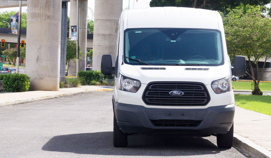 View of a white private shuttle on the road