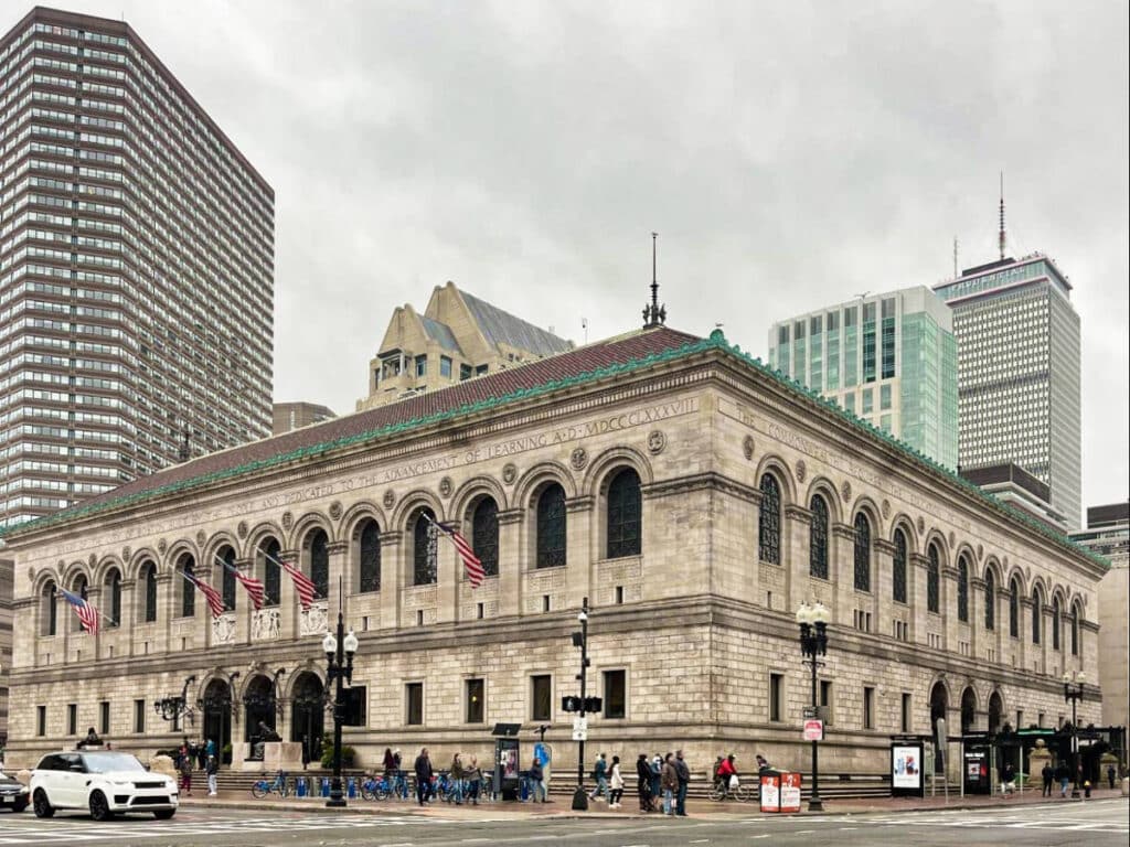 View of the facade of Boston Public Library at the corner of the street in Copley Square