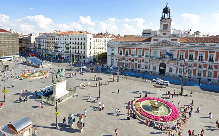 Overlooking view of people hanging around Puerta del Sol