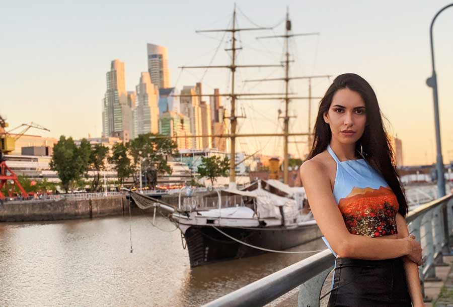 Clara posing for a photo during sunset in Puerto Madero