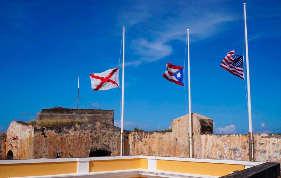 View of flags on a pole and the clear blue sky over it