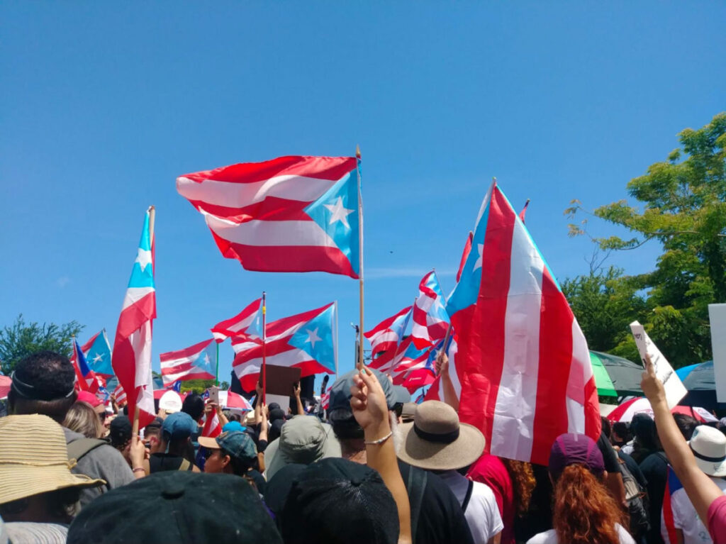 People protesting while holding the Puerto Rico flag in 2019