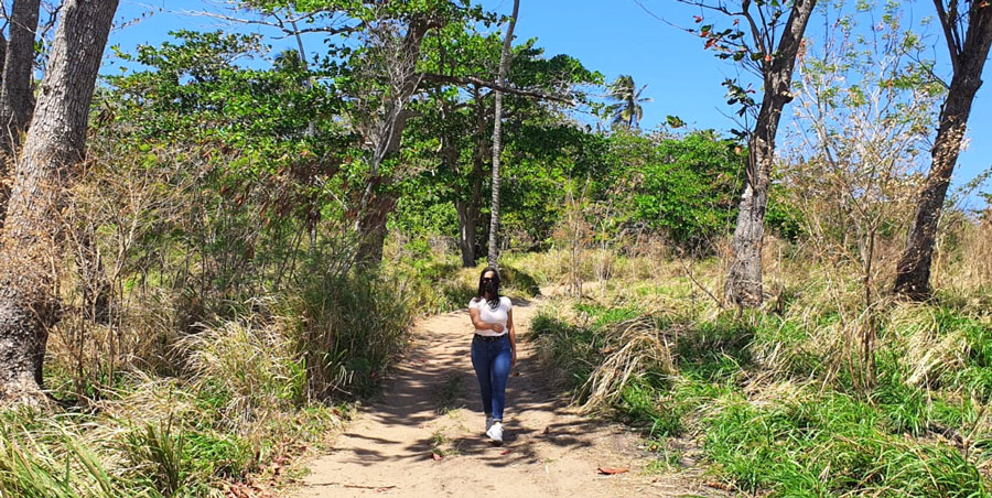 The author Vanessa Ramos walking in the middle of the wilderness