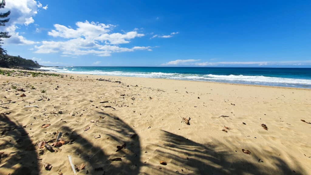 View of the white sand and calm ocean in Punta Borinquen Beach