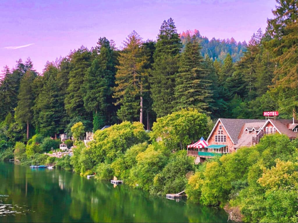 View of the pink and purple sky over a hotel near the lake in Sonoma County