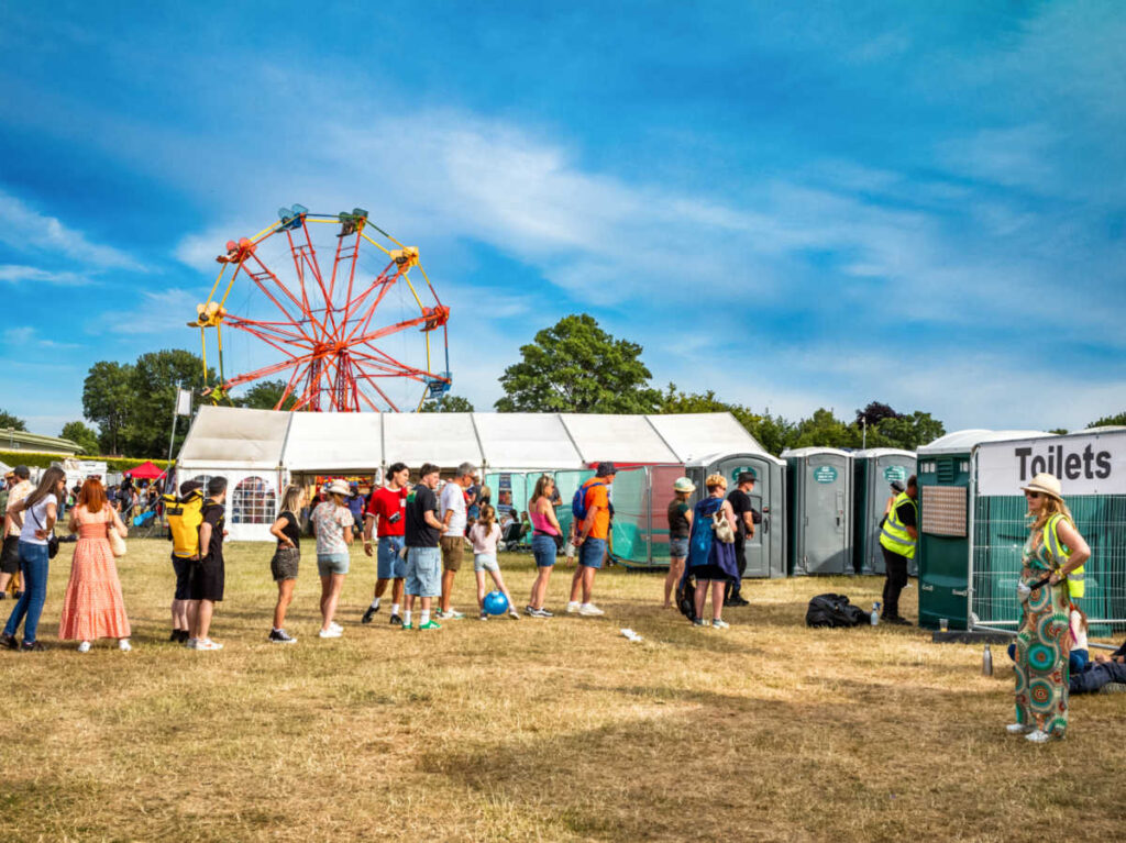 People queueing at the toilet at a festival