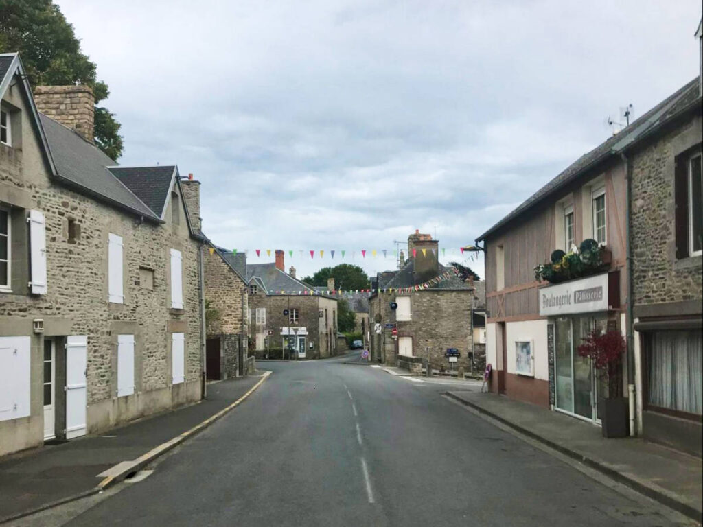 A quiet road surrounded by brick buildings in Normandy
