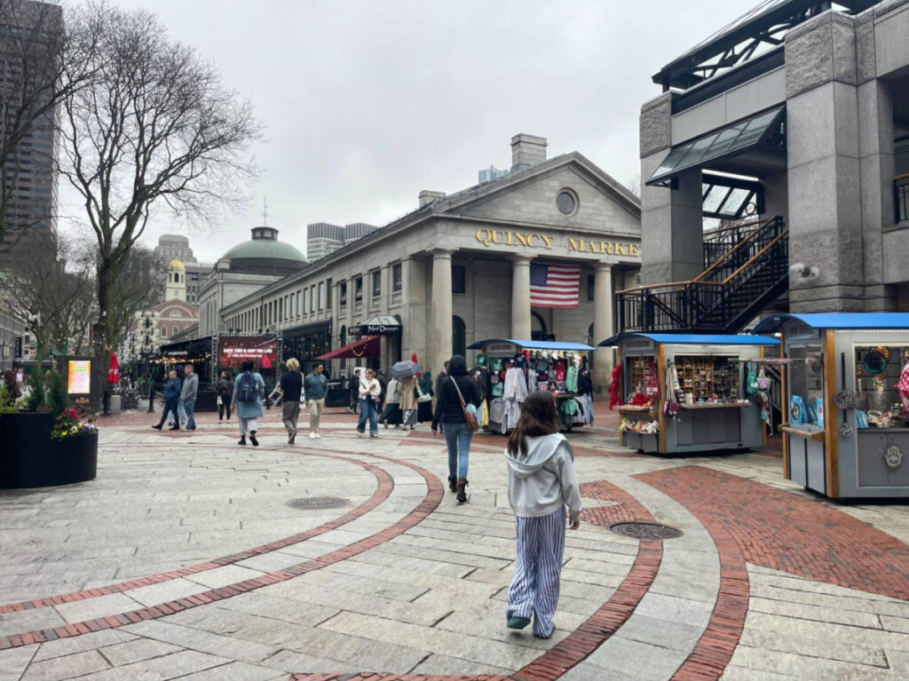 People wandering around the Quincy Market in Downtown Boston