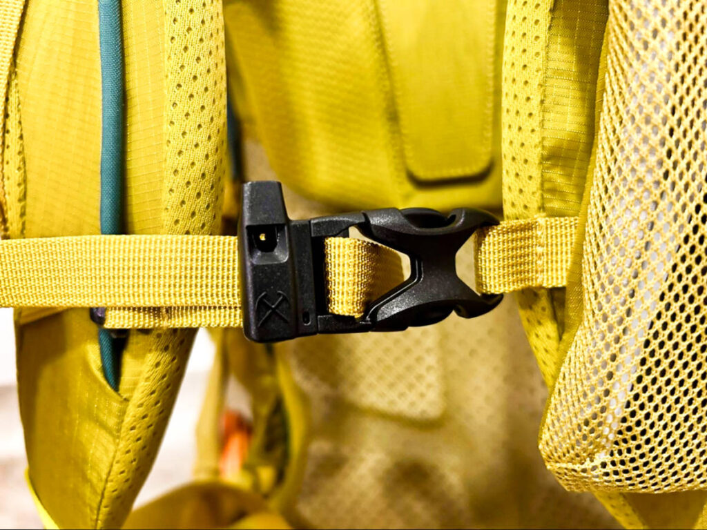 Closeup look at the sternum strap buckle and whistle of the REI Co-Op Flash 55 Backpack