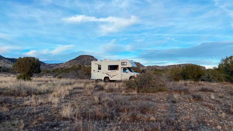 An RV under the clear blue sky at a camping site