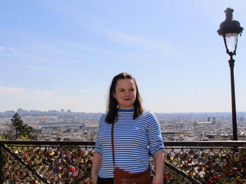 The author Rachel Kapelke-Dale and the view of Paris from her background