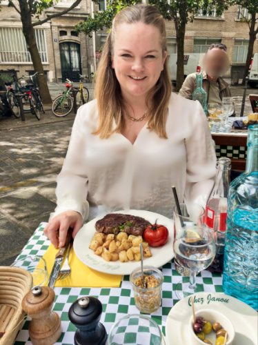 The author Rachel Kapelke-Dale, posing with her plate of steak at the terrace of Chez Janou