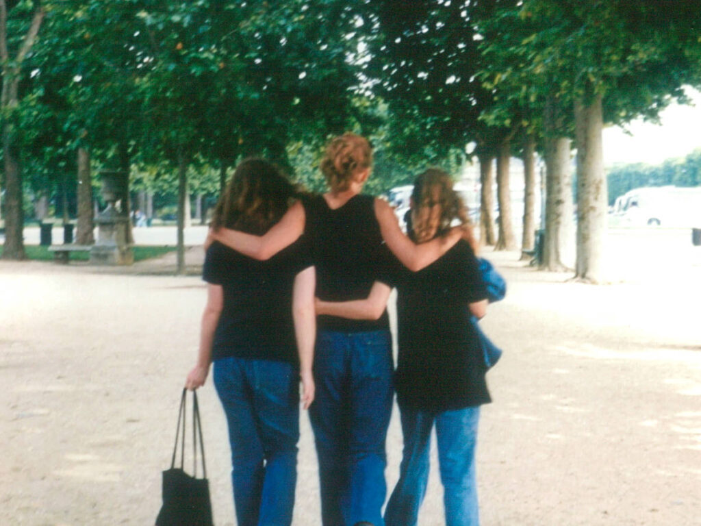 The author Rachel and her sisters walking together at the Tuileries Garden in 1999