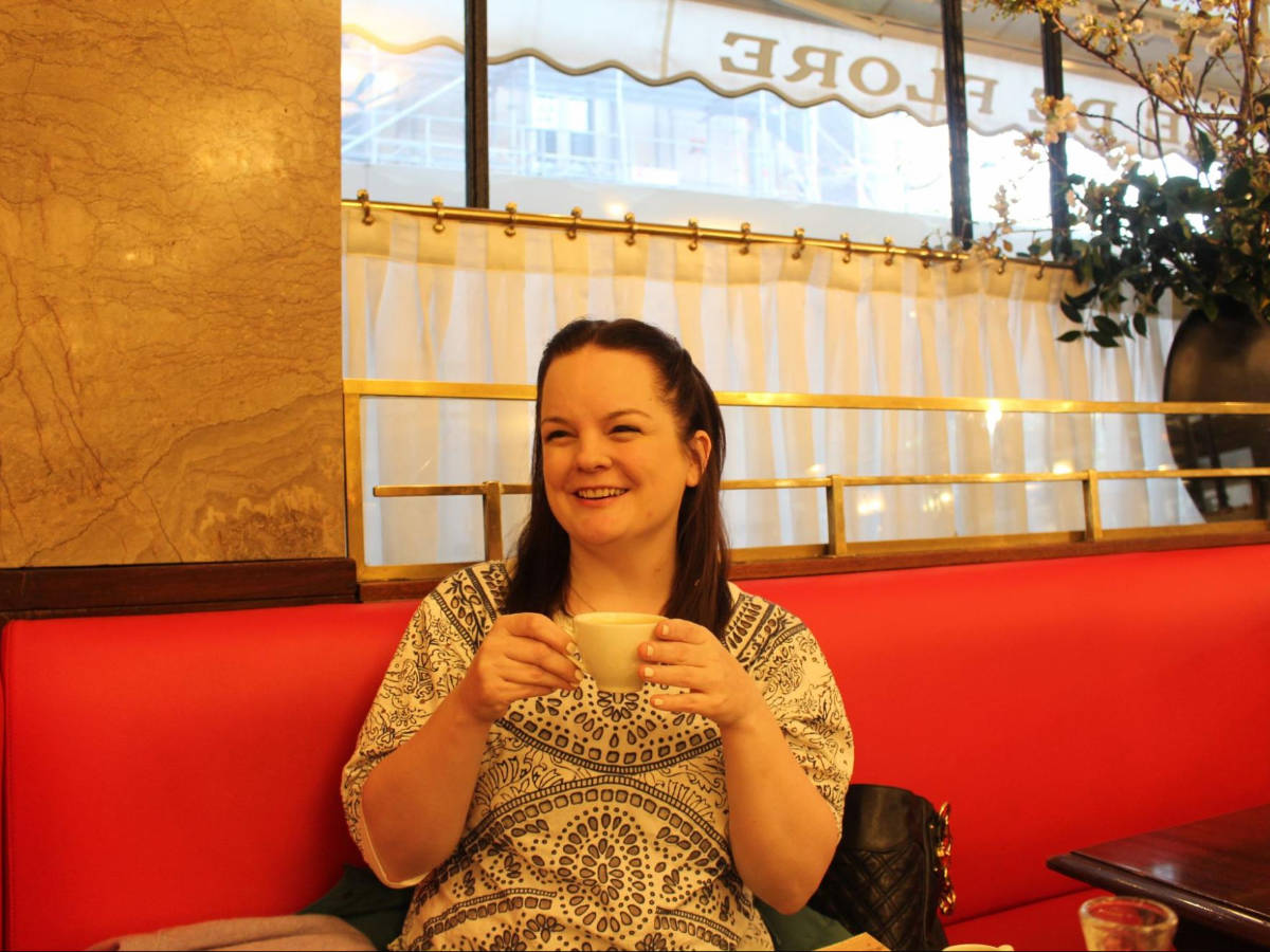 The author Rachel Kapelke-Dale enjoying her coffee at the Cafe de Flore