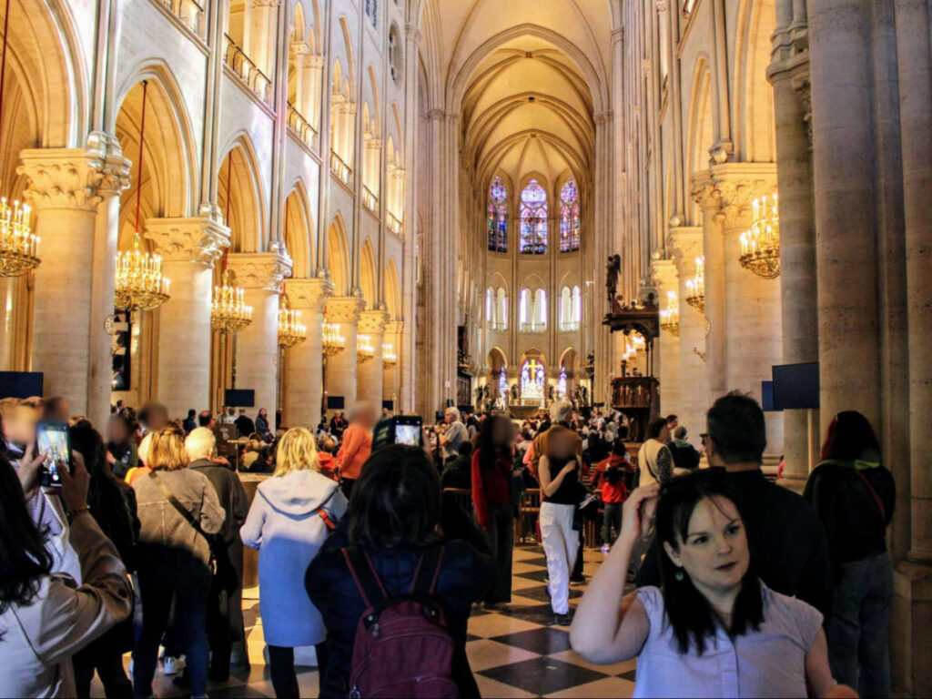 The author Rachel Kapelke-Dale at the entryway with the crowd to Notre Dame