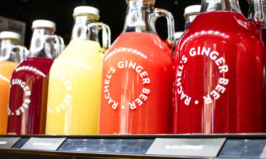 Bottles of different flavors of Rachel’s Ginger Beer displayed on a shelf
