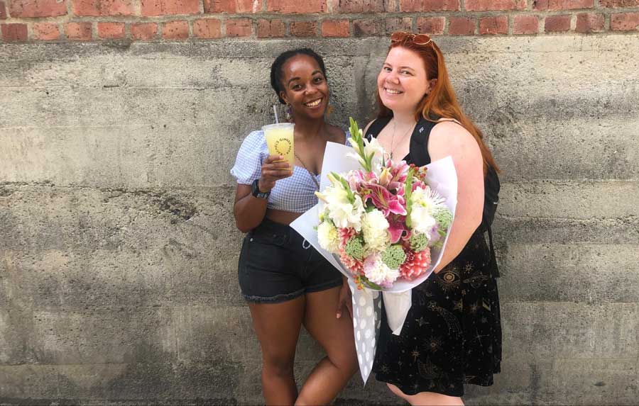 The author with her friend posing for a photo in Pike Place Market
