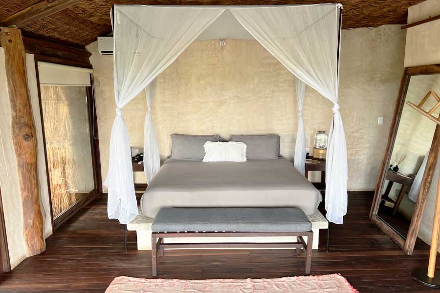 View of a bed inside a room in Radhoo Tulum
