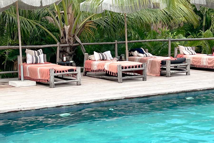 Pool chairs on the pool area in Radhoo Tulum