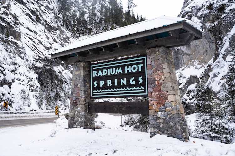 Sign welcoming visitors to Radium Hot Springs in the winter