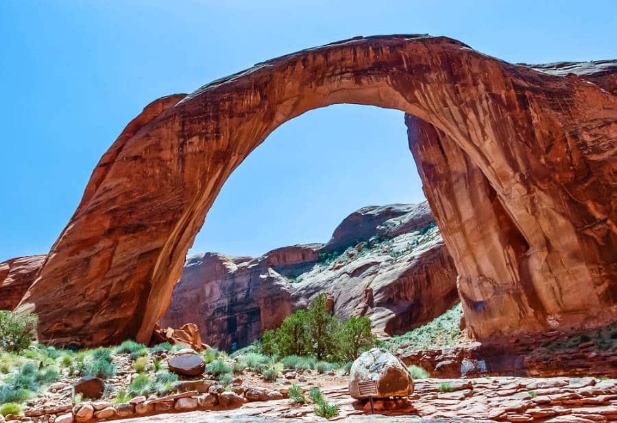 View of the scenic Rainbow Bridge National Monument under the clear blue sky