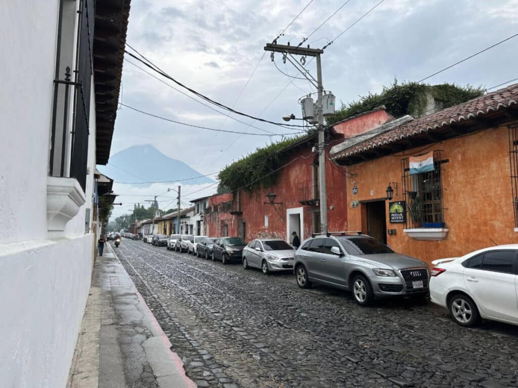 Cars parked on a street in Antigua after a rain