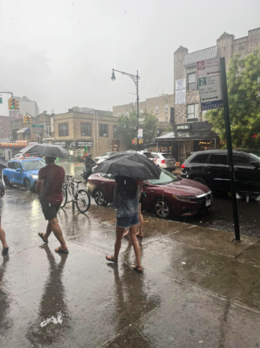 People holding umbrella during a rainy day in April