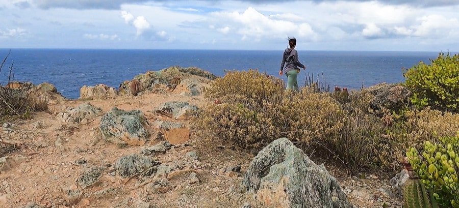 A woman overlooking the beach view at Ram Head Peak on St. John